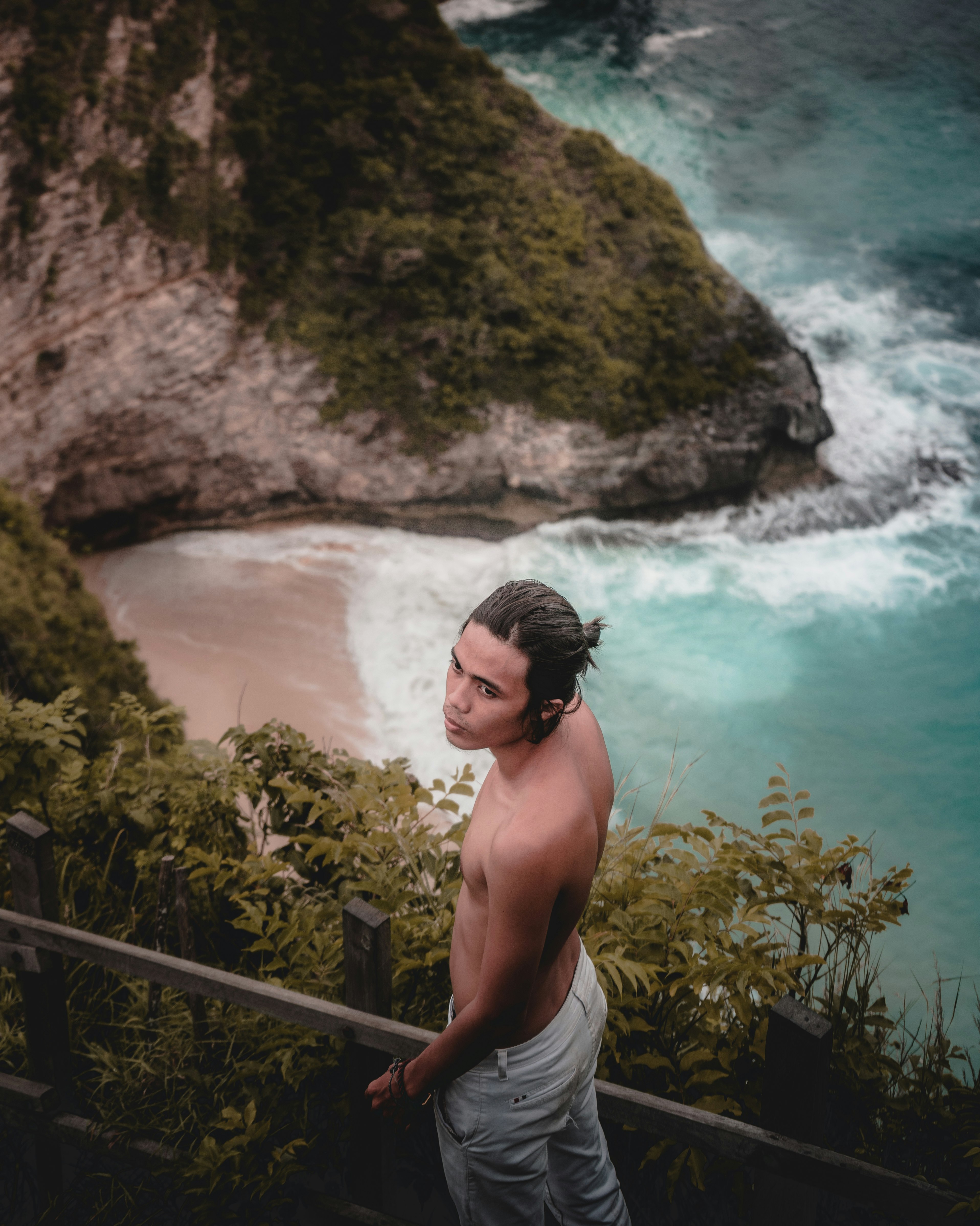 man in white shorts standing near body of water during daytime